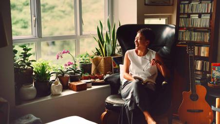 Women happily sitting in her living room